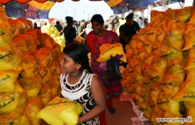 Army troops provide assistance to distribute dry rations among the needy